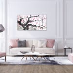 Painting of cherry blossoms, pink blossoms, black branches with grey touches on a wall in a modern living room