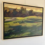 framed painting of rolling green field with trees and sunset glow