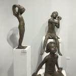 bronze sculpture, The Little Bather, Béatrice Cols, Belgian artist, bronze child sculpture, girl in swimsuit, figurative art, tying ponytail, natural patina, poetic sculpture, contemporary bronze, interior decor, garden sculpture, patinated bronze, art collector piece