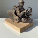 “Master of Speed V” bronze sculpture by Lieven D’Haese, showing a figure seated in a stylised vehicle with a small bird perched on the front.