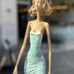 walking on a dream contemporary woman sculpture of Hedwige Leroux city girl in earphone listening to music and in green dress like a flower summer look bronze sculpture figurative sculpture at Art Yi gallery in Brussels