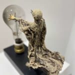 Visionary XL with light boy sculpture bronze sculpture of Lieven d'Haese garden sculpture boy opening arms to light up a light bulb in his hands with imagination magic dream contemporary art sculpture light interior design at Art Yi gallery in Brussels
