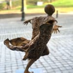 Almost flying lieven d'haese contemporary bronze sculpture a boy opening up his arm against wind to fly child sculpture childhood flying sculpture garden sculpture garden art design Art Yi art gallery in brussels