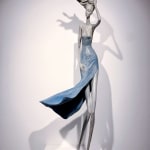 hedwige leroux, gone with wind, contemporary woman sculpture, a beautiful young girl walking in the wind with her blue dress fly to the sky Art Yi gallery Brussels art yi gallery