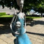 Fifth avenue contemporary woman sculpture Hedwige Leroux a young girl under a blue dress blowing in the wind while carry a little dog in her bag bronze sculpture Art Yi gallery Brussels art gallery