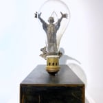 Visionary lieven d'haese contemporary bronze sculpture of a boy turn a light bulb on with his imagination and his inspiration a sculpture art of dream Art Yi art gallery in brussels