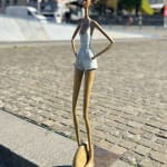 Urban freedom contemporary woman sculpture of Hedwige Leroux modern city girl on a wheel city walk bronze sculpture figurative sculpture at Art Yi gallery in Brussels