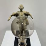 Visionary XL with light boy sculpture bronze sculpture of Lieven d'Haese garden sculpture boy opening arms to light up a light bulb in his hands with imagination magic dream contemporary art sculpture light interior design at Art Yi gallery in Brussels