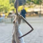 Urban freedom contemporary woman sculpture of Hedwige Leroux modern city girl on a wheel city walk bronze sculpture figurative sculpture at Art Yi gallery in Brussels