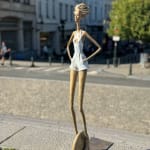 Urban freedom contemporary woman sculpture of Hedwige Leroux modern city girl on a wheel city walk bronze sculpture figurative sculpture at Art Yi gallery in Brussels