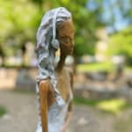 Stand by me woman sculpture Hedwige Leroux contemporary art contemporary sculpture interior design a sculpture of lying young city girl in jean and listen to music a sitting girl listen to music with her earphones Art Yi gallery Brussels art gallery