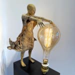 IIXV Visionary XL with light boy sculpture bronze sculpture of Lieven d'Haese garden sculpture boy opening arms to light up a light bulb in his hands with imagination magic dream contemporary art sculpture light interior design at Art Yi gallery in Brussels