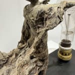 Visionary XL with light boy sculpture bronze sculpture of Lieven d'Haese garden sculpture boy opening arms to light up a light bulb in his hands with imagination magic dream contemporary art sculpture light interior design at Art Yi gallery in Brussels