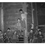 A triptych photograph from the section "Many Many Years" of Chen Qiulin's work "Another Day" where shows a female performer dances outside of living room of village women.