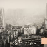 A fleshcolor sticky note is pasted on a black and white photograph of Village Yangji, Guangzhou by artist Li Lang
