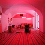 A barber shop is relocated into a room with pinkish neon lights in 2006