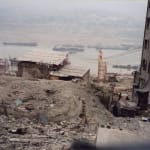 It is a video still from Farewell Poem 2002 that shows a view of a ruined construction site near the river from far above.