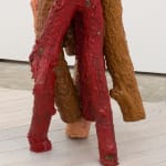Detail of red and brown wood logs sculpture by Andrew Sabin