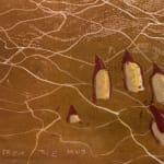 Hand with long red nails sinking in mud print by Alexi Marshall