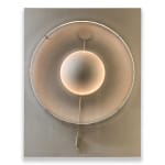 Silver-toned kinetic wall sculpture by Damien Bénéteau featuring a central rotating disc inside a circular form, lit with integrated LED light on an anodised aluminium panel.