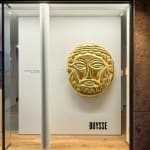 Gold-leaf mask sculpture by Florian Tomballe based on ancient Greek funerary forms.