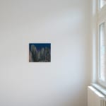 Painting titled “The Ancient Sleep” (2021) by Silvia Giordani. The artwork depicts towering, textured stone formations in muted greens and grays, set against a gradient sky transitioning from deep blue to soft pink. A glowing gap between the rocks suggests a warm light beyond. Acrylic and oil on canvas. © Buysse Gallery.