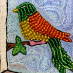 beaded image of bird in orange and green