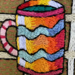 detail of embroidery showing striped mug