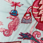 embroidery primarily red and blue, depicting a family of seahorses -- child