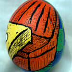 dyed egg showing edge of yellow table and orange banquette