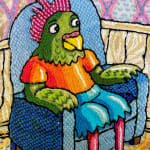 embroidery showing a bird sitting in an armchair