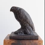 close up of sculpture of raptor on wood base
