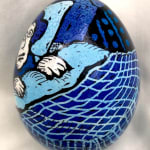 dyed egg showing woman in blue bed
