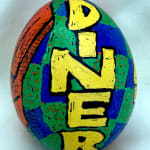 dyed egg showing the word "Diner" in yellow