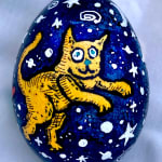 dyed egg showing yellow cat with starry background
