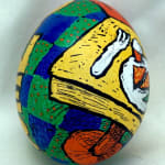 dyed egg showing yellow table and green and blue floor tiles