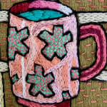 detail of embroidery showing mug with stars