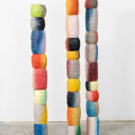 three colorful wooden totem sculptures