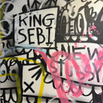 Detail photo of “King Sebi”, painting by Flore artist from Brooklyn, based between Florida and NY. Available at Carousel Fine Art Atlanta. The artist's technique combines acrylic on canvas with a blend of pop and street art. Layered words and hidden meanings reveal society's complexities, while the vibrant colors invite viewers to explore and interpret the unfolding story. Colors of this work : Light Blue, Yellow, Green, Pink, Black, White