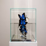“Love Lock Sky”, sculpture by Roman Feral artist from France, based in Miami. Available at Carousel Fine Art Atlanta. The artist's technique involves transforming the ephemeral into the timeless, which has become his signature. He integrates ancestral luxury techniques with the magnificence of butterflies, suspended in endless flight, creating a unique artistic universe imbued with purity and delicacy that captivates beyond languages and borders. Colors of this work : Blue, Black, White