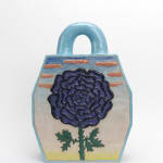 View of the back of Cosmic Handbag: Black Rose. A large purple flower with its petals outlined in black and a green thorny stem sits in front of a light blue, beige, and green sky with orange clouds.