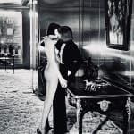Helmut Newton, Woman in Coat Adjusting Stocking, Paris 1975, 1978