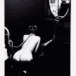 Helmut Newton, Woman in Coat Adjusting Stocking, Paris 1975, 1978