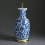 A mid-eighteenth century porcelain vase of good scale, decorated with scrolling foliage in blue glazes, mounted as a lamp