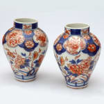 A pair of late 17th century Edo period Imari small vases with floral motifs.