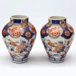 A pair of late 17th century Edo period Imari small vases with floral motifs.