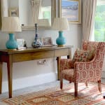 Chair upholstered in Susan Deliss Padishah linen in red blue cream