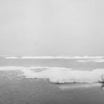 Black-and-white photograph of a museum diorama of ice sheets floating on a calm sea
