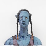 Image of the sculpture: bust of a blue-skinned and yellow-eyed Avatar-character with dark-haired braids adorned with orange beads.