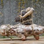Sculpture in ceramic and ropes of a goat on an amphora by Chada